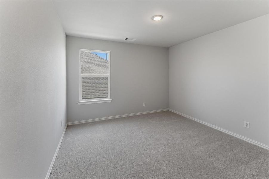 Neutral gray carpeting extends across the floor, complemented by light gray wall finishes and white trim