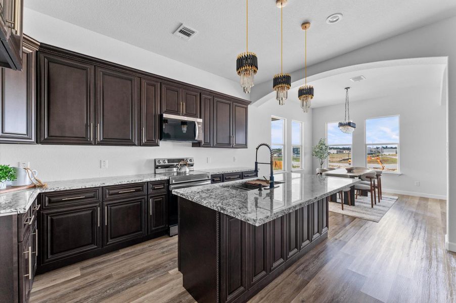 Chef’s kitchen featuring 60" custom cabinetry to the ceiling, granite countertops, stainless steel appliances, and a large prep-friendly layout. Chef’s kitchen featuring 60" custom cabinetry to the ceiling, granite countertops, stainless steel appliances, and a large prep-friendly layout.