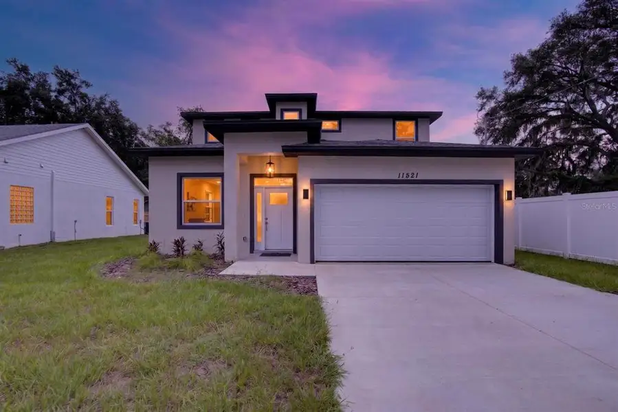 Front exterior of a new home in , Thonotosassa, FL, highlighting curb appeal (Image 2). Front exterior of a new home in , Thonotosassa, FL, highlighting curb appeal (Image 2).