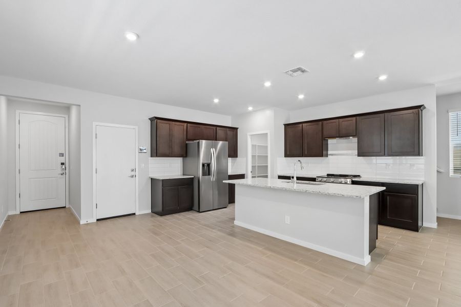 A kitchen with white cabinets.