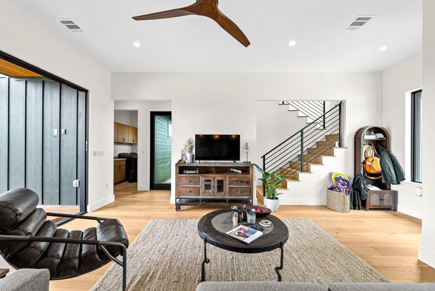 Warm hardwood floors and clean architectural lines define this welcoming living space.