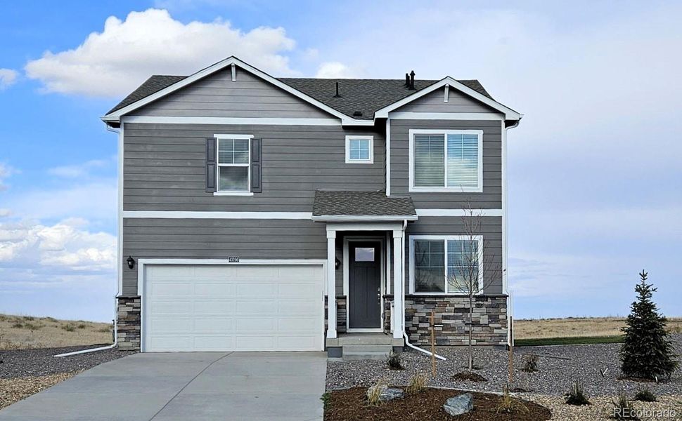 Front exterior of a new home in Spring Valley Ranch, Elizabeth, CO, highlighting curb appeal (Image 1). Front exterior of a new home in Spring Valley Ranch, Elizabeth, CO, highlighting curb appeal (Image 1).