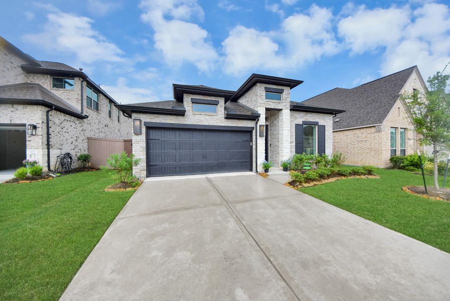 Front exterior of a new home in , Humble, TX, highlighting curb appeal (Image 26).
