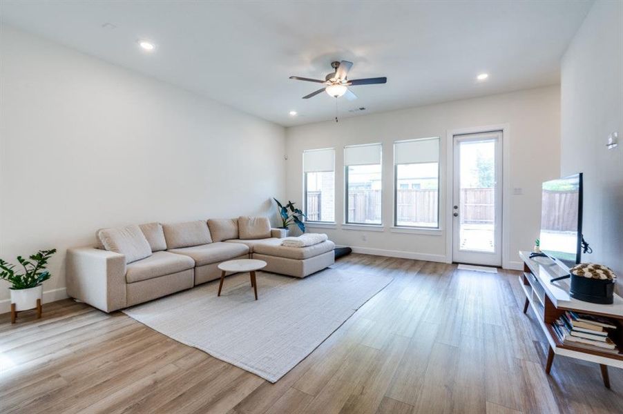 Living area featuring light wood-style floors, recessed lighting, and ceiling fan Living area featuring light wood-style floors, recessed lighting, and ceiling fan