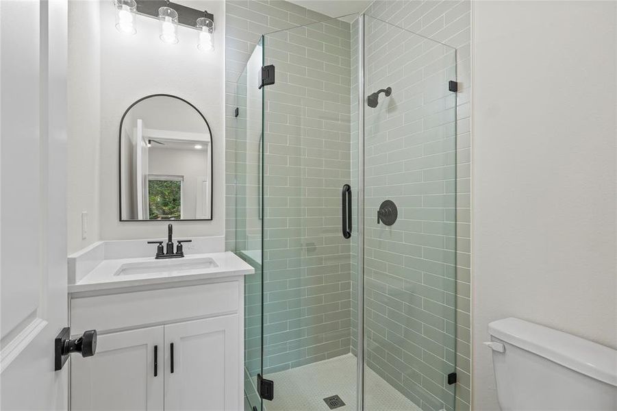 Bathroom featuring vanity and a shower stall Bathroom featuring vanity and a shower stall