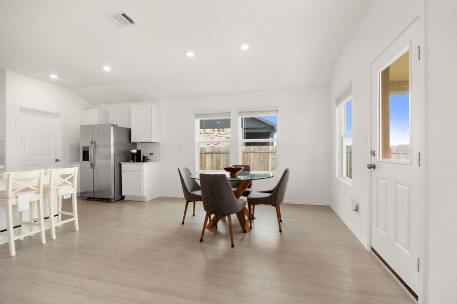 An inviting eat-in kitchen area features smooth flooring and ample natural light, creating an ideal gathering space.