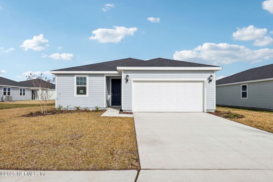 Front exterior of a new home in Lakes at Bella Lago - Signature Series, Green Cove Springs, FL, highlighting curb appeal (Image 21).