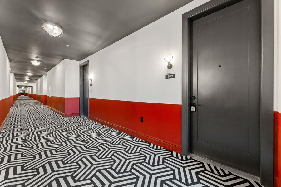 Hallway with baseboards and carpet flooring