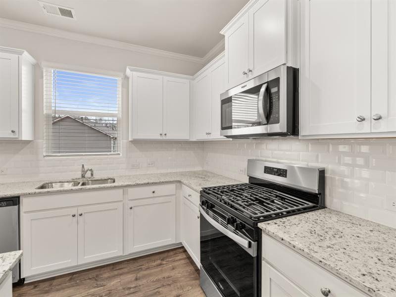 Furnished interior view inside a new home in Northwoods at Mirror Lake, Villa Rica (Image 6).
