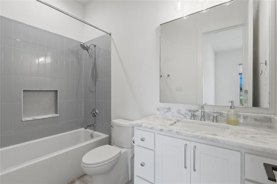 Bathroom featuring a white vanity with a marble-finish countertop, undermount sink, and chrome fixtures