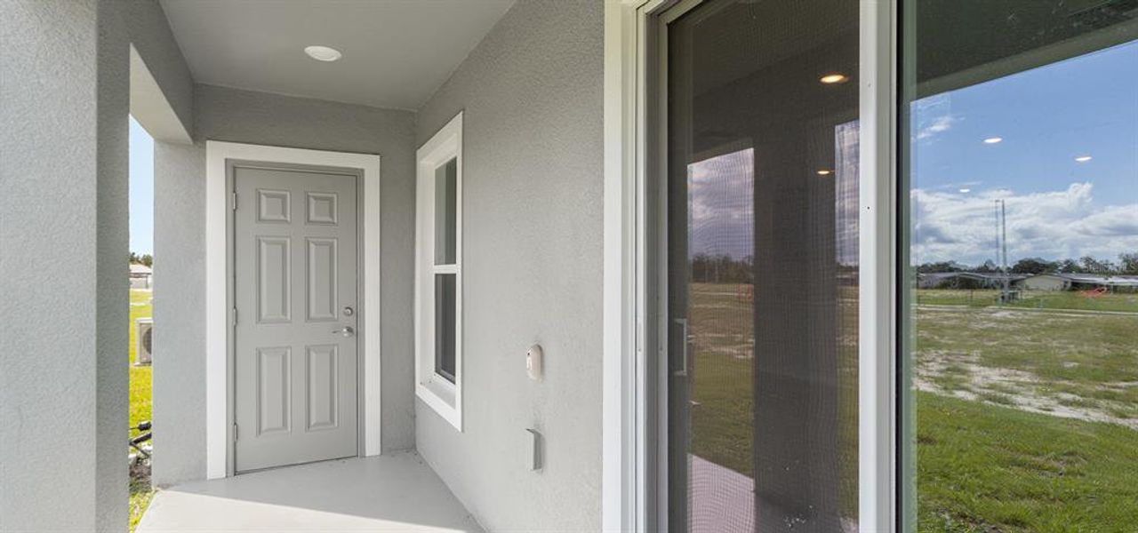 Exterior details and patio area of a home in Harbor at Lake Henry - Townhomes, Winter Haven (Image 2).
