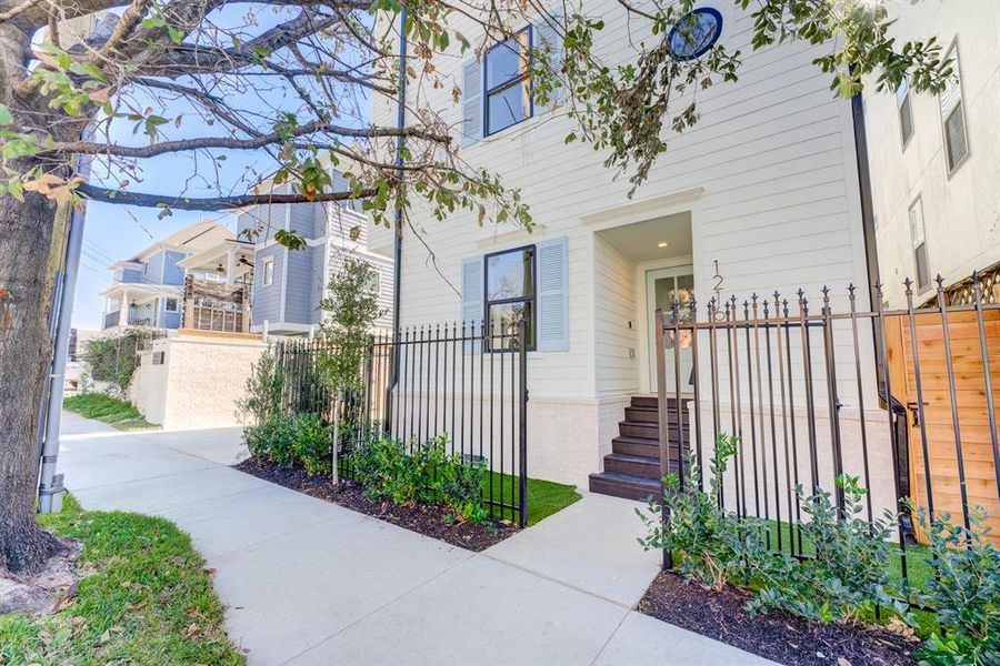 Ultimate city living with the wrought iron fencing, newly paved sidewalks, and beautiful corner lot.