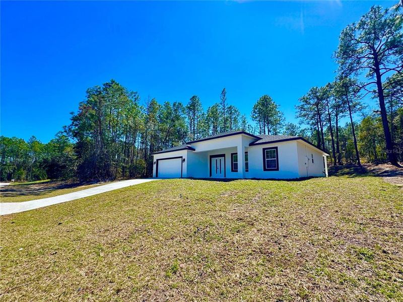 Front exterior of a new home in , Citrus Springs, FL, highlighting curb appeal (Image 13).