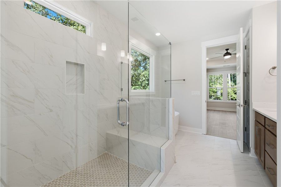 An elegant tile shower with a built-in bench ancho