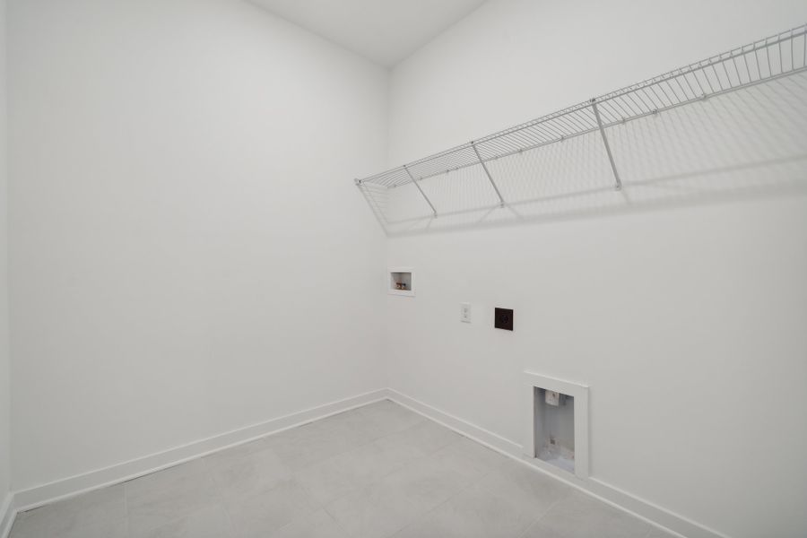 A white hallway with a metal railing. A white hallway with a metal railing.