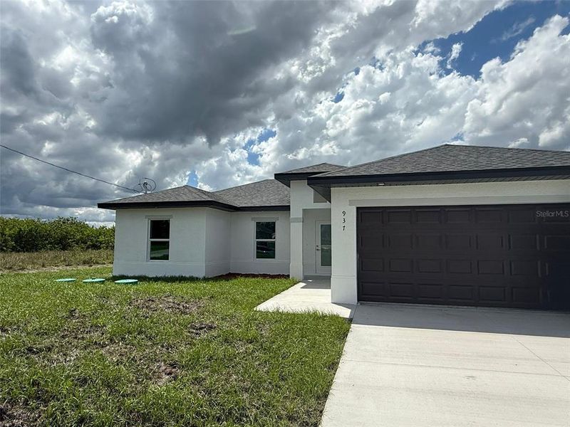 Front exterior of a new home in , Lehigh Acres, FL, highlighting curb appeal (Image 19).