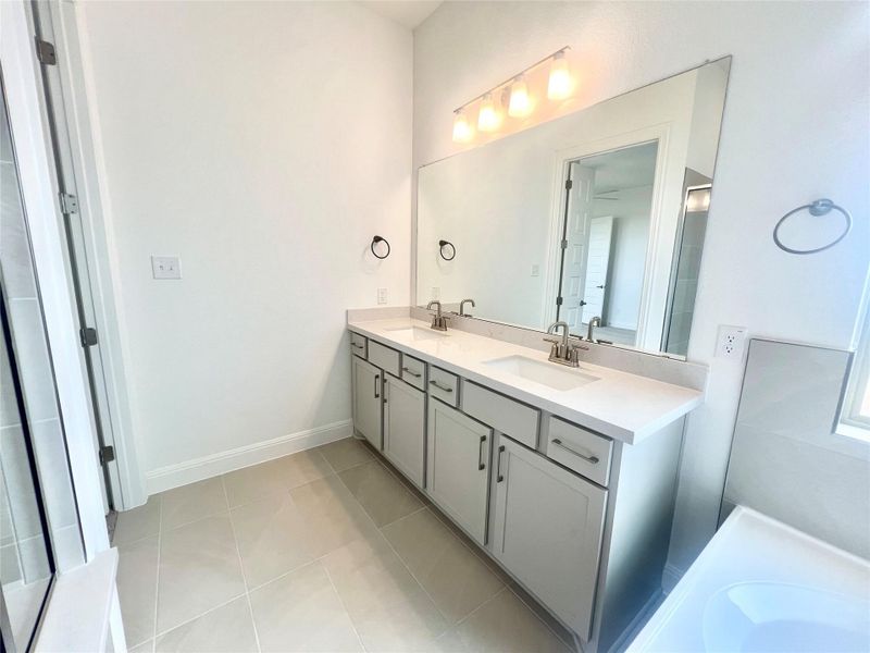 Full bath featuring double vanity and tile patterned floors Full bath featuring double vanity and tile patterned floors
