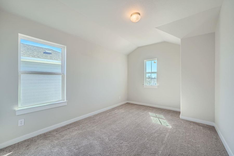 Bonus room featuring carpet floors, vaulted ceiling, and baseboards