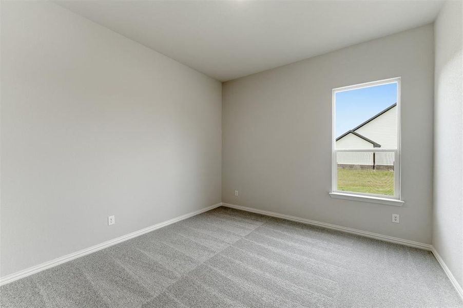 Unfurnished room with light carpet and baseboards