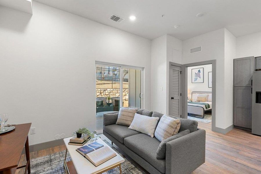 Living area featuring light wood finished floors and recessed lighting