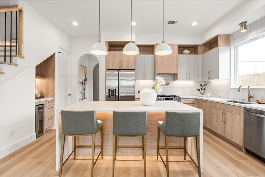 From this angle you can see how efficiently the floor plan works — kitchen, coffee nook, and stairs all within a few steps of each other, with nothing wasted. It's a layout built for how people actually move through a home.