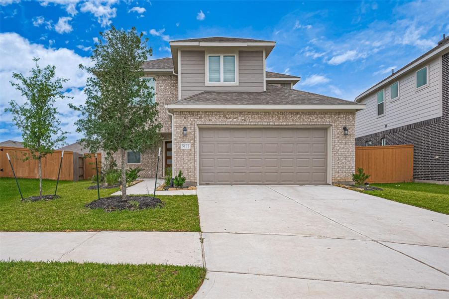 Front exterior of a new home in Sunterra, Katy, TX, highlighting curb appeal (Image 25).