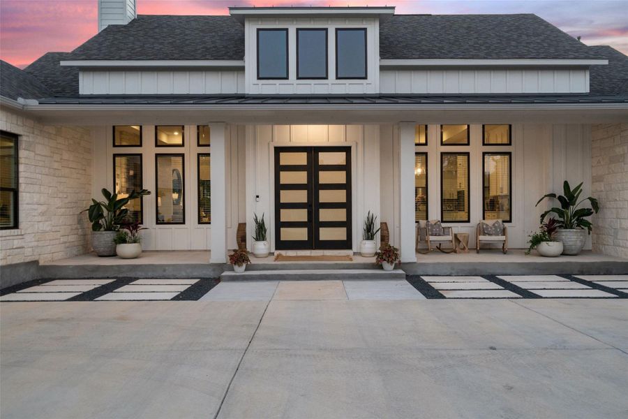 Modern stone and siding residence with a welcoming front porch and decorative entry door. Modern stone and siding residence with a welcoming front porch and decorative entry door.