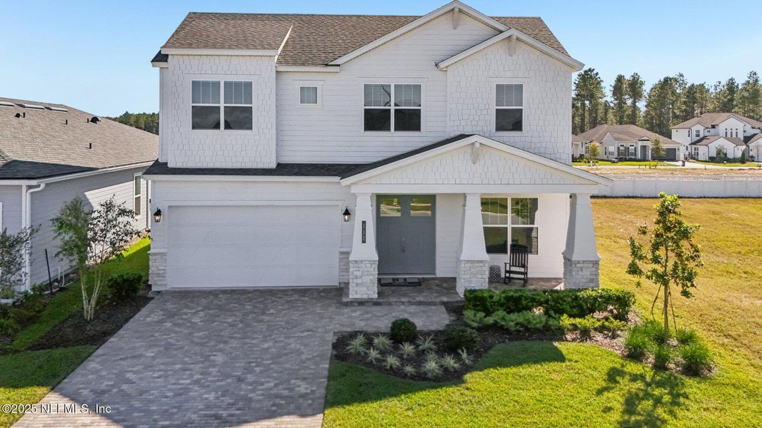 Front exterior of a new home in Courtney Chase, St. Augustine, FL, highlighting curb appeal (Image 28). Front exterior of a new home in Courtney Chase, St. Augustine, FL, highlighting curb appeal (Image 28).