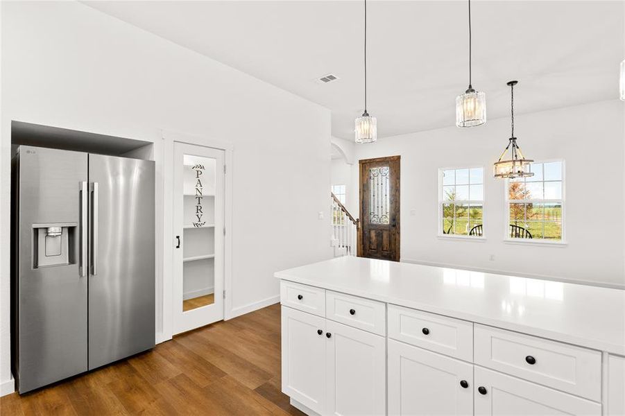 Kitchen island with white cabinetry and a light-toned countertop