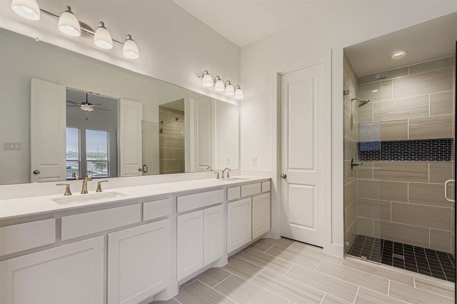 Main bathroom with a shower stall, double vanity, ceiling fan, and recessed lighting Main bathroom with a shower stall, double vanity, ceiling fan, and recessed lighting