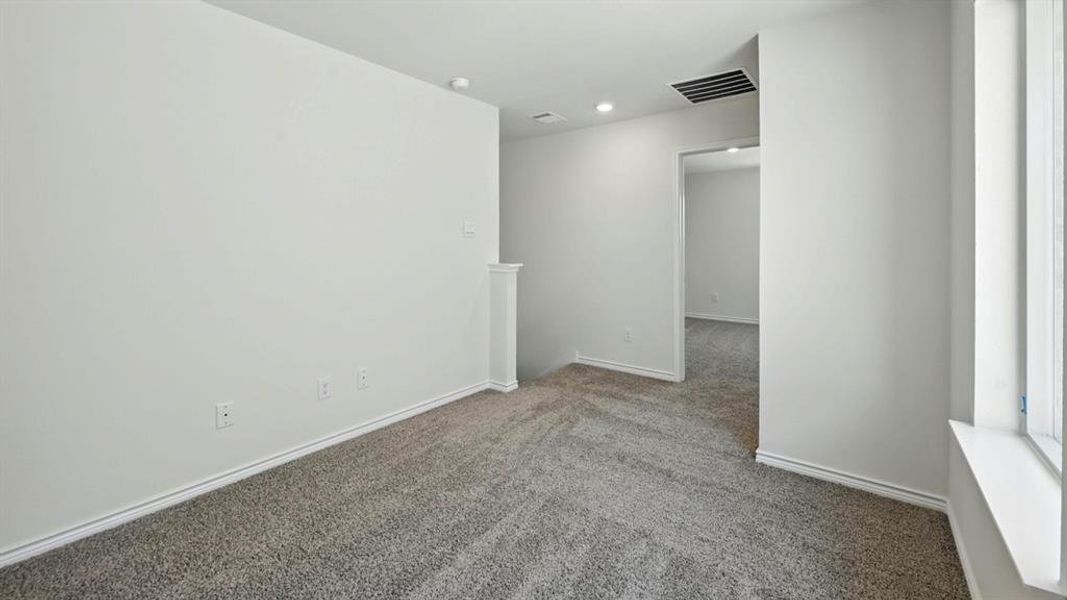 Carpeted spare room featuring baseboards and recessed lighting