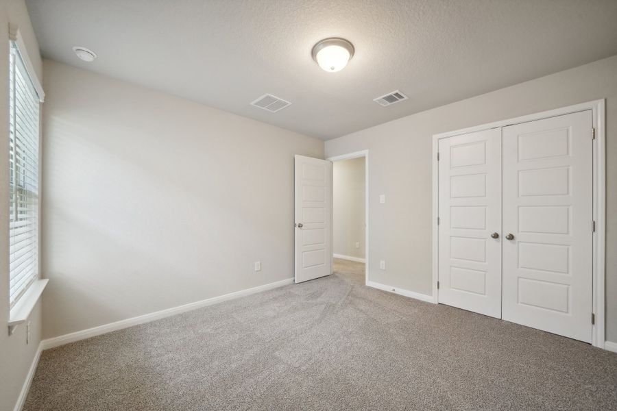 Guest bedroom in the Matador floorplan in the Meritage Homes community.