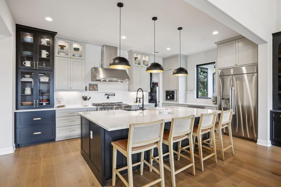 The gourmet kitchen is a true showstopper, dazzling with sleek quartz surfaces and modern design. Create culinary masterpieces with professional-grade appliances and ample counter space.