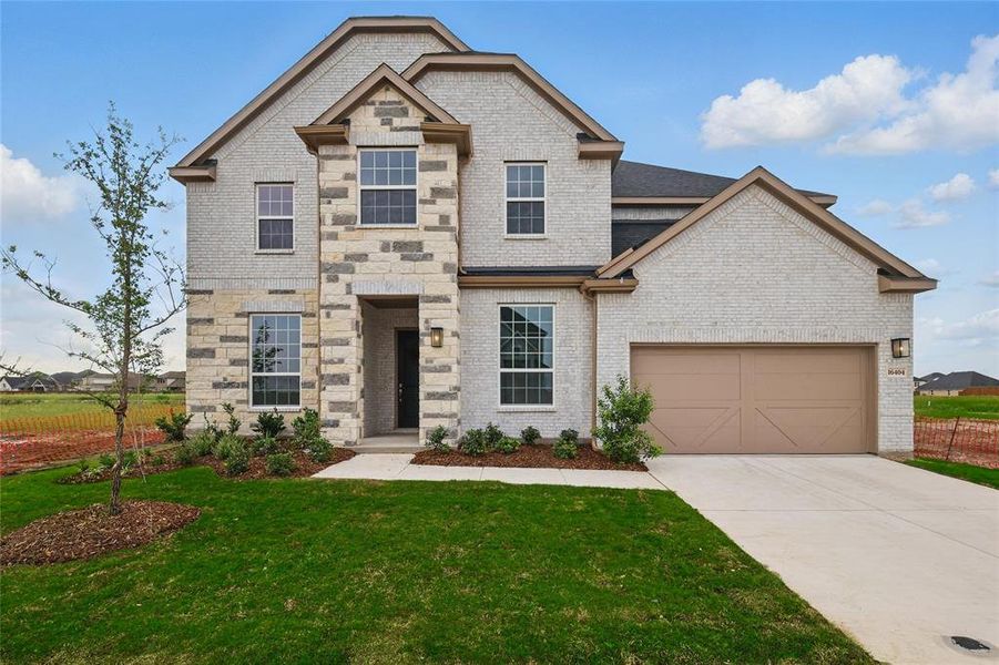View of front of home featuring an attached garage, brick siding, driveway, and a front yard View of front of home featuring an attached garage, brick siding, driveway, and a front yard