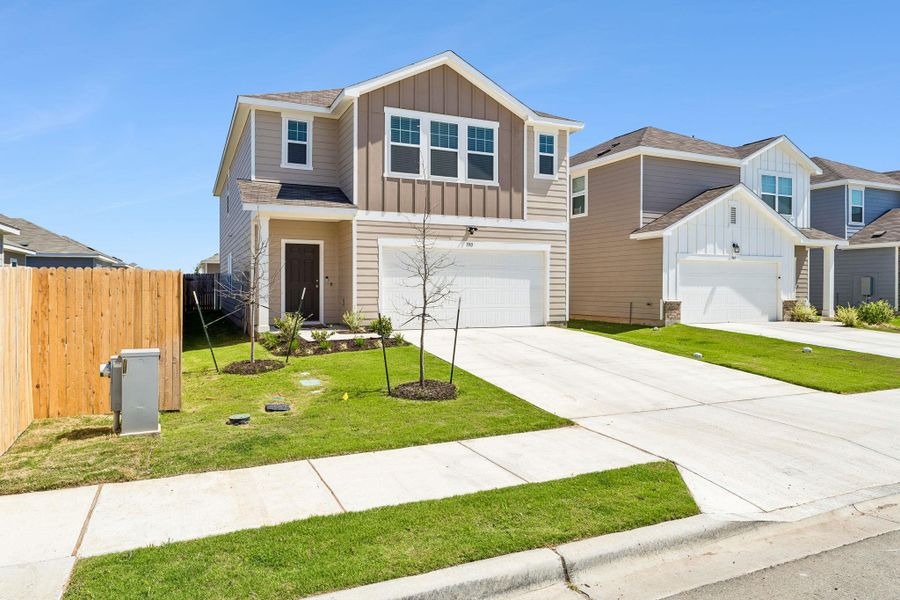 View of front facade featuring board and batten siding, an attached garage, and concrete driveway