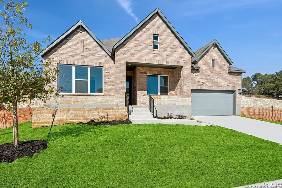 Front exterior of a new home in Windsong - Legacy Series, Boerne, TX, highlighting curb appeal (Image 23).