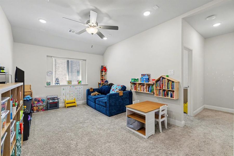 Carpeted room featuring a ceiling fan with integrated lighting, recessed lighting, and a window with blinds