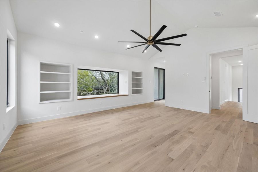 Built-in's balance the central window seat with its wide north-facing view to the back of the property. The hallway leading  to the Bath has a door out to a small balcony to survey that large space.