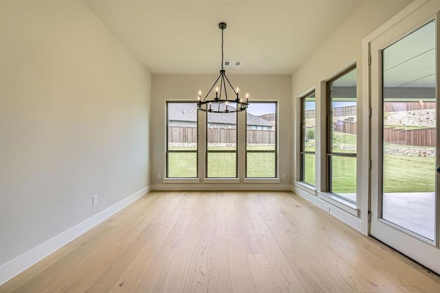 Unfurnished sunroom featuring a chandelier Unfurnished sunroom featuring a chandelier