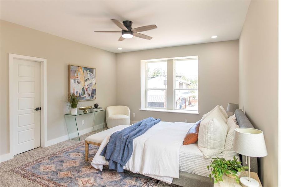 Bedroom with ceiling fan and carpet floors