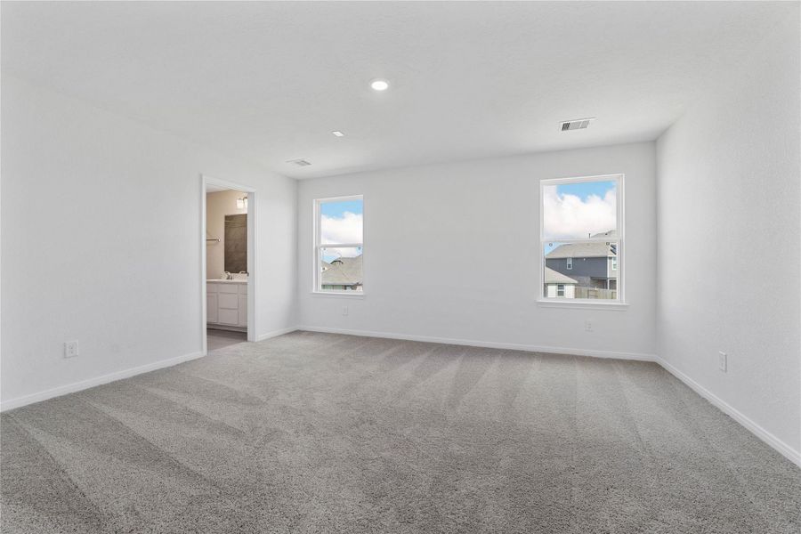 Relax and recharge in this stunning primary suite! This expansive room offers plush carpeting, neutral-toned walls, high ceilings, and large windows—perfect for unwinding after a long day. Relax and recharge in this stunning primary suite! This expansive room offers plush carpeting, neutral-toned walls, high ceilings, and large windows—perfect for unwinding after a long day.