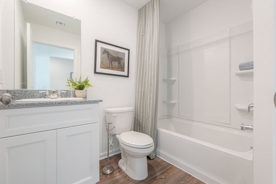 A bathroom with a toilet and bathtub. A bathroom with a toilet and bathtub.