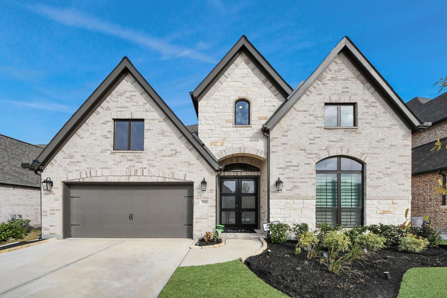 Inviting front entry with covered porch and detailed brickwork.