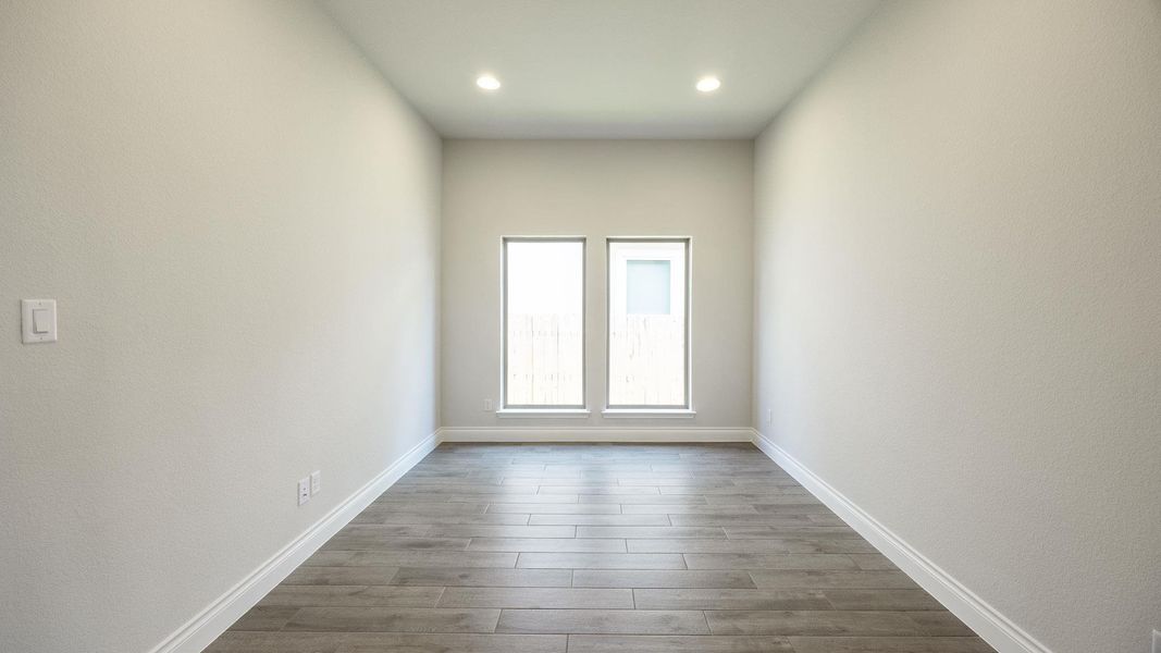 Spare room with baseboards, recessed lighting, and dark wood-type flooring Spare room with baseboards, recessed lighting, and dark wood-type flooring