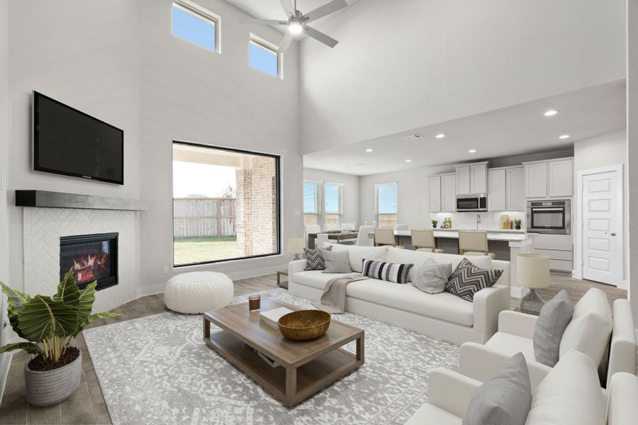 VS. Welcome family and guests to your charming living room! With its high ceilings, recessed lighting, ceiling fan, custom paint, beautiful flooring, and large windows that let in abundant natural light, this room is perfect for gatherings. Sample photo of completed home with similar floor plan. Actual colors and selections may vary.