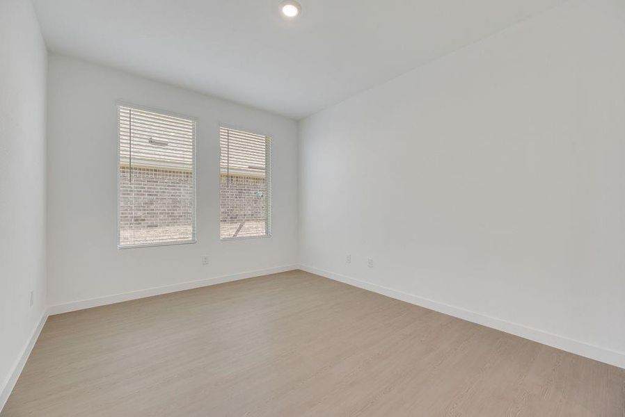 Unfurnished room with light wood-style flooring and recessed lighting Unfurnished room with light wood-style flooring and recessed lighting