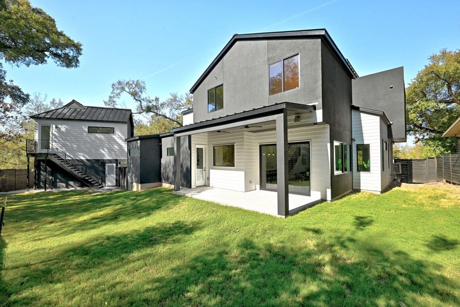 Rear view of backyard featuring a patio and privacy with plenty of space for a pool plus completely fenced backyard Rear view of backyard featuring a patio and privacy with plenty of space for a pool plus completely fenced backyard