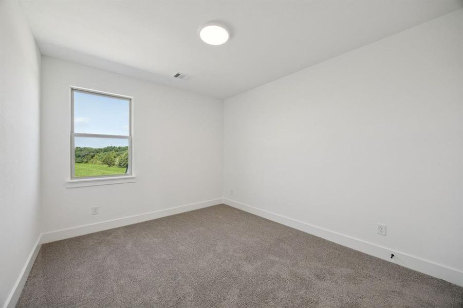 Unfurnished room with baseboards and carpet floors Unfurnished room with baseboards and carpet floors