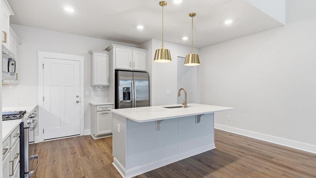 Memorable meals begin in this vibrant kitchen with pendant lighting and a thoughtfully designed island in Anderson, SC Memorable meals begin in this vibrant kitchen with pendant lighting and a thoughtfully designed island in Anderson, SC