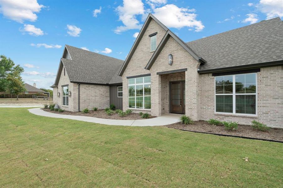 Front exterior of a new home in , Rhome, TX, highlighting curb appeal (Image 20).